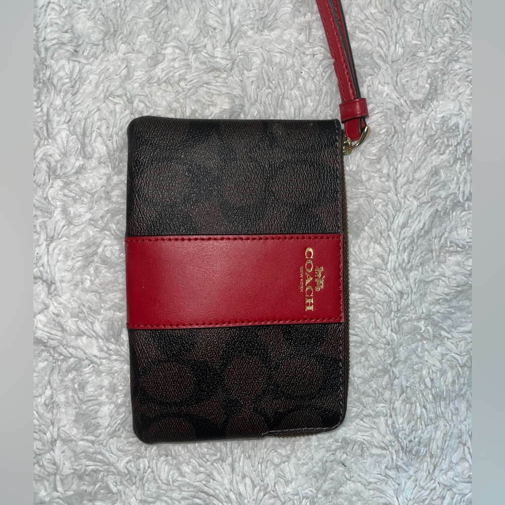 Coach bag with red wrist strap